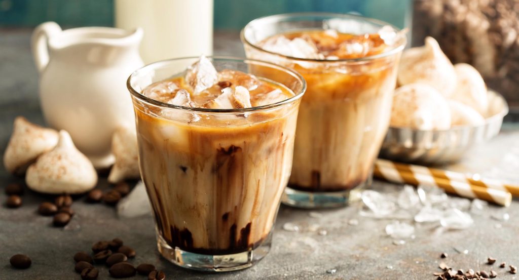 Iced coffee with milk, chocolate syrup and meringues.